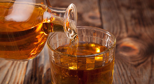 Whiskey being poured into a glass.